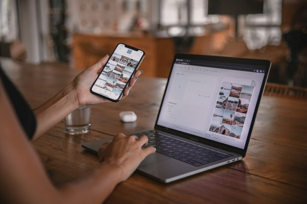 Woman at a desk with a laptop and phone setting up business email