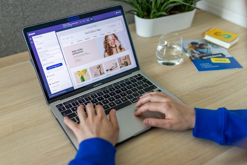Hands typing on a keyboard while setting up an online store